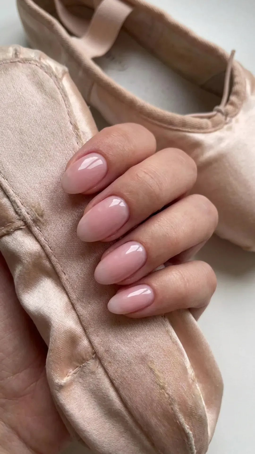 Soft pink nails inspired by the delicate color of ballet slippers, offering a glossy finish that exudes grace and poise.
