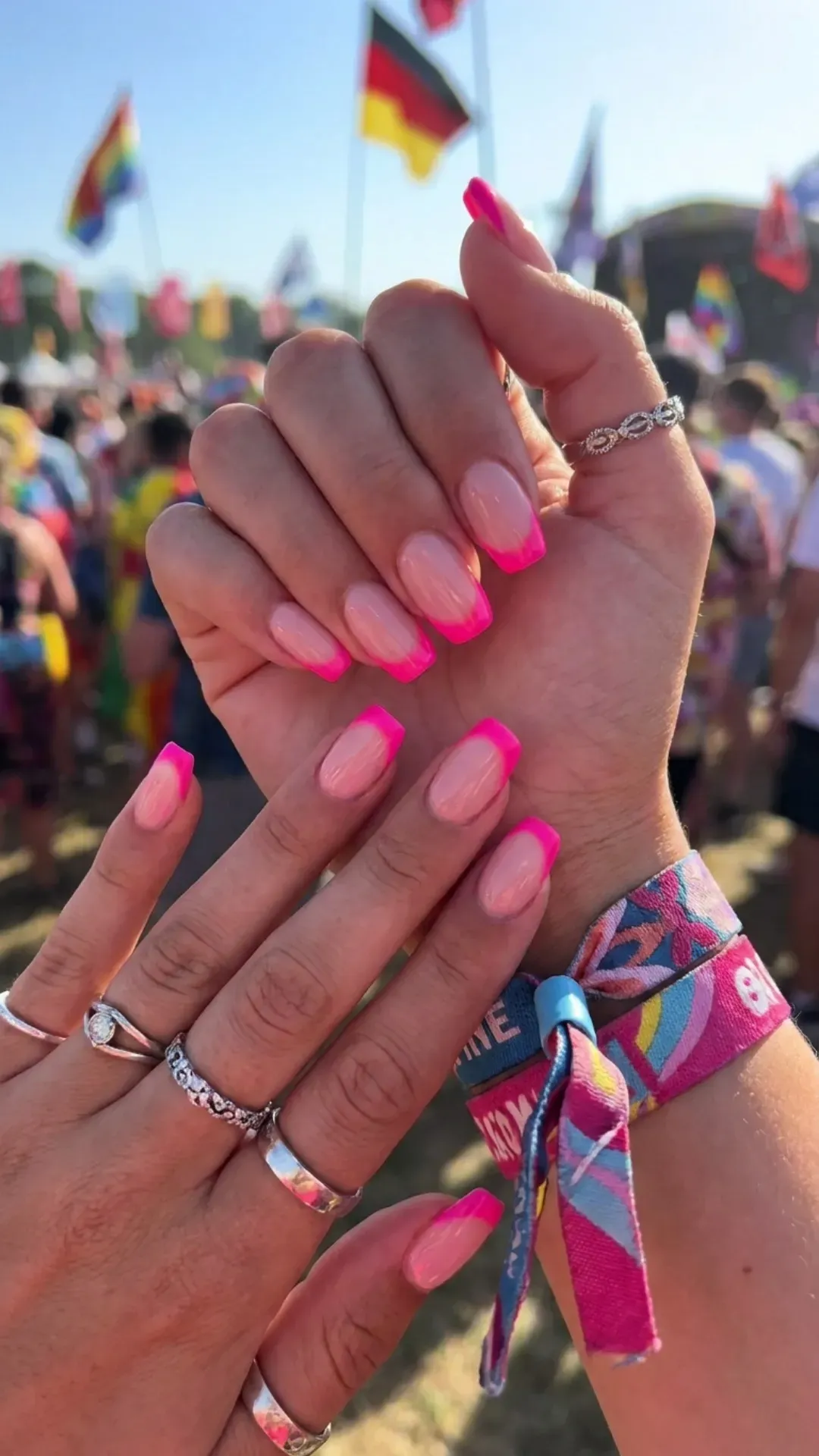Eye-catching nude pink nails with striking neon pink tips, providing a pop of vibrant color that's trendy and perfect for summer festivals or adding a splash to your daily attire.