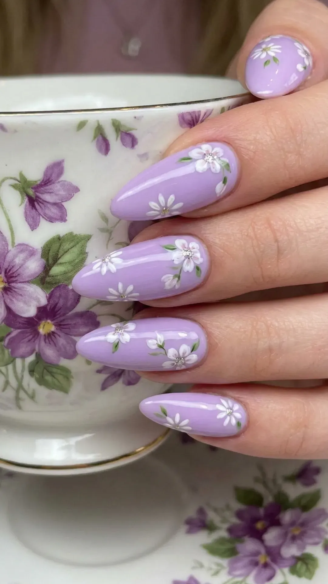 Lavender Nails with Floral Accents - Glossy lavender nails featuring hand-painted white spring flowers