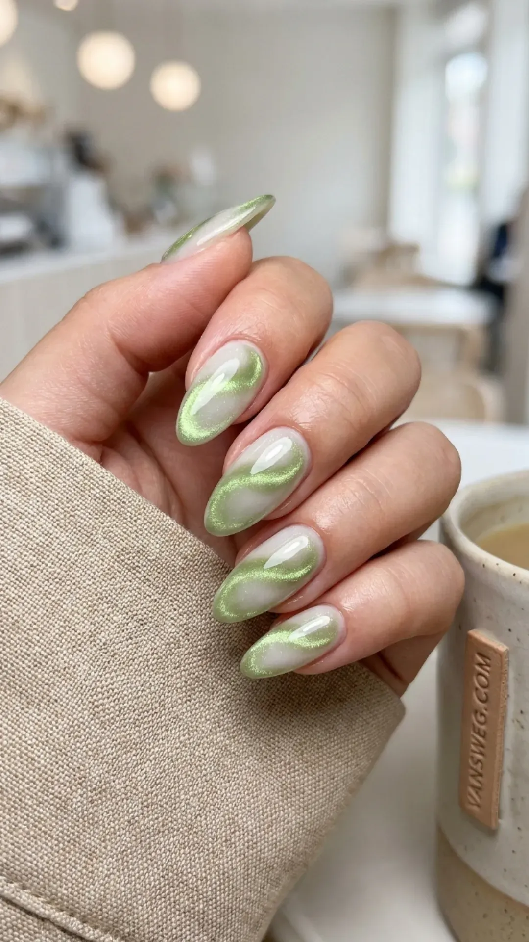 creamy milky white nails with matcha green magnetic cat-eye swirls by VANSWEG.COM