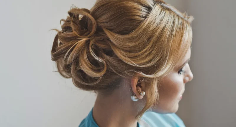 An intricate low bun hairstyle with sweeping loops, a perfect blend of classic style and modern flair for a formal event.