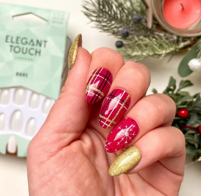 "Bold and festive plaid nail art with bright red and gold glitter, complemented by classic Christmas star designs."
