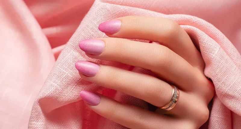 Almond-shaped nails featuring a frosted sugar almond finish, with a pink base and sparkling sugar-like topping