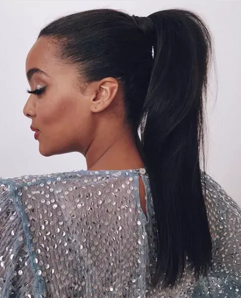 Profile view of a woman with a sleek high ponytail, the smooth texture and flawless finish making it ideal for an evening look.
