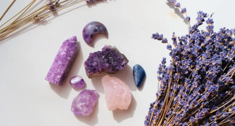 A serene arrangement of various crystals, including amethyst and rose quartz, paired with a bouquet of dried lavender, evoking a sense of calm and spiritual healing.