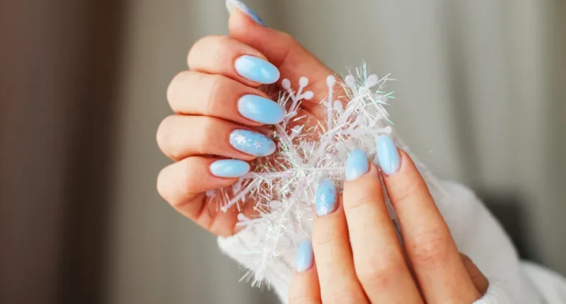 Icy blue nails adorned with delicate crystal accents, emulating the frosty sparkle of a winter morning for a glamorous manicure