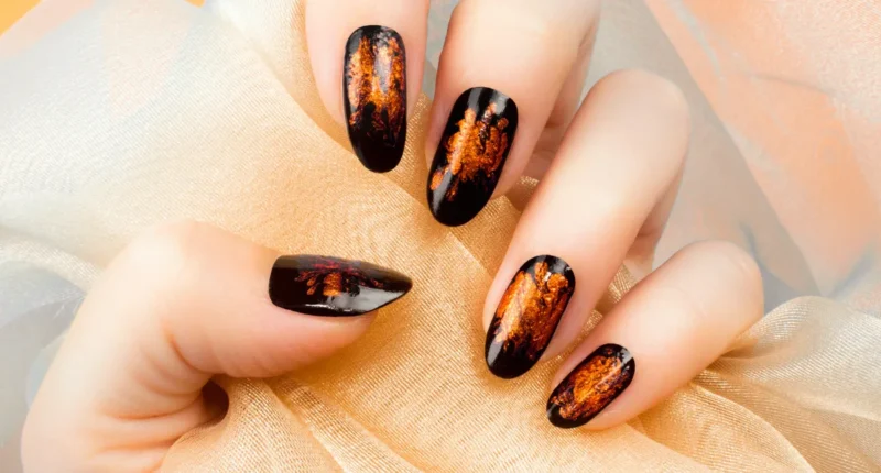 Sleek almond-shaped nails with a luxurious tortoiseshell design, showcasing a glossy finish with swirls of black, amber, and brown.