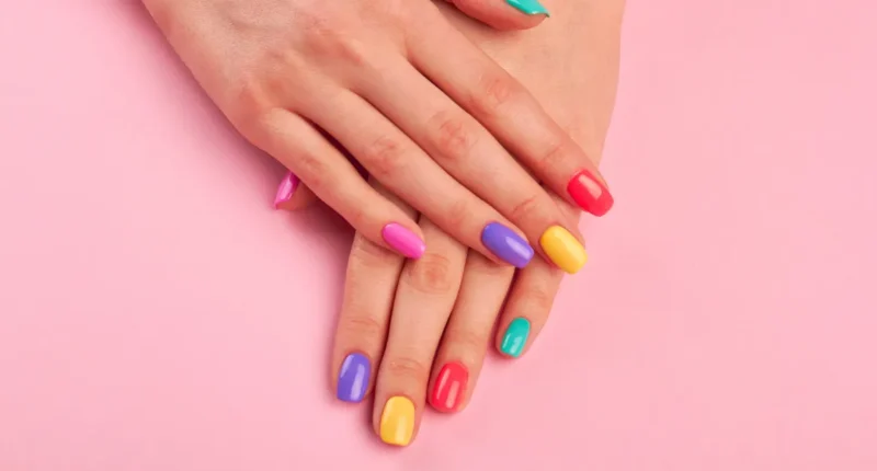 A playful take on the French manicure with each nail tip painted in a different bright, spring color, creating a rainbow effect against the natural nail base.