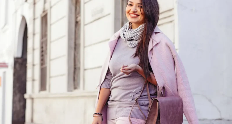 Soft and feminine plus size winter fashion with a layered lavender coat over a grey ensemble, accessorized with a scarf for added warmth.