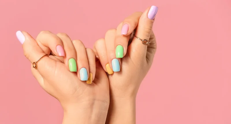 Soft pastel rainbow nails in almond shape, reflecting the early signs of spring during the last month of winter.