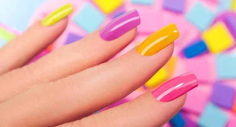 Multicolor nails in yellow, pink, and purple, showcasing the vibrant and diverse color trends for summer 2024.