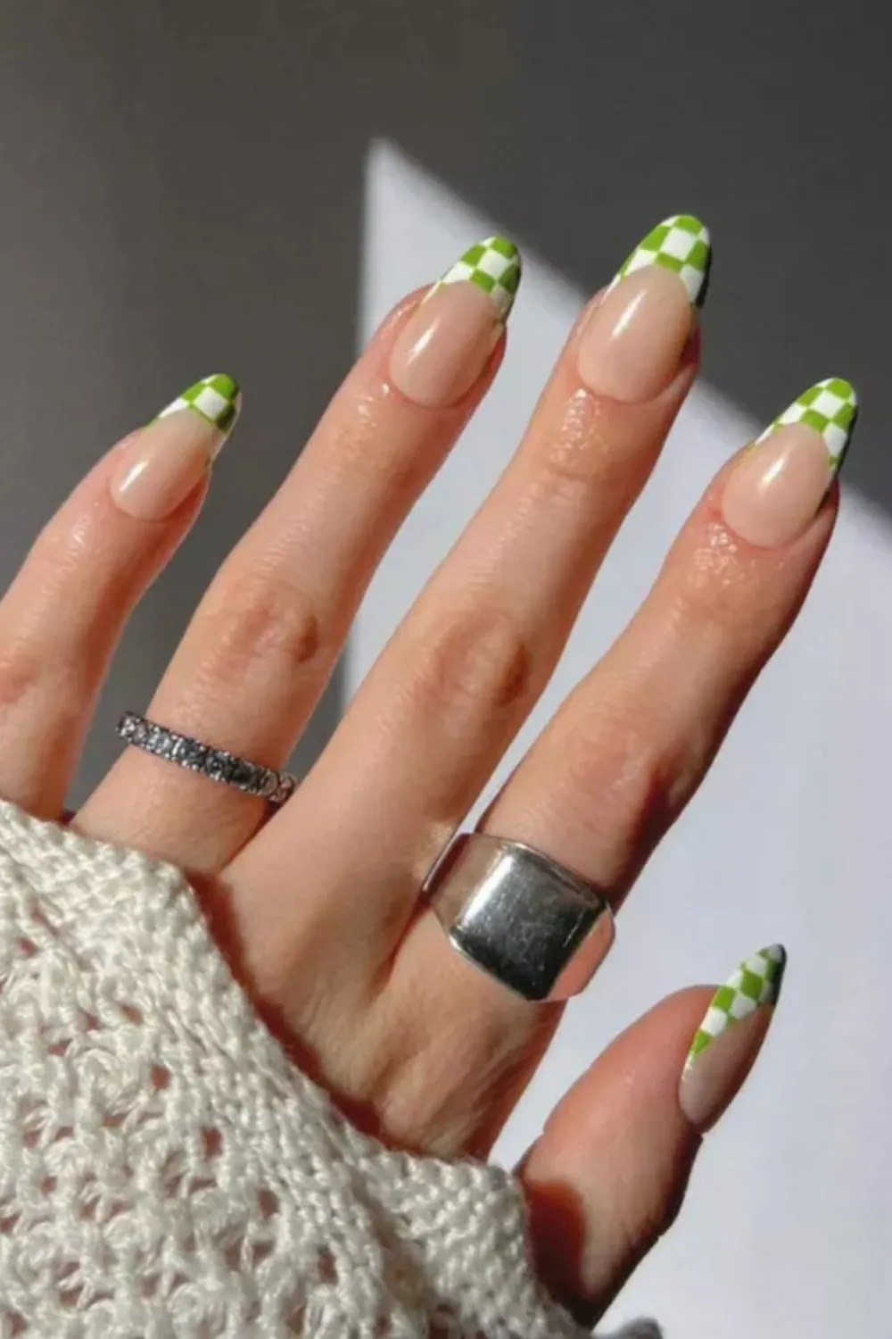 Nails adorned with a green and white checkerboard pattern for a playful design.

